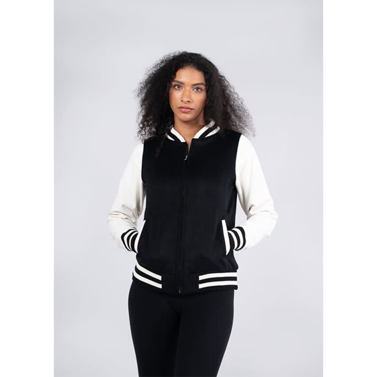 A black and cream varsity jacket with a zip front, striped cuffs, and side pockets. It features a branding logo.