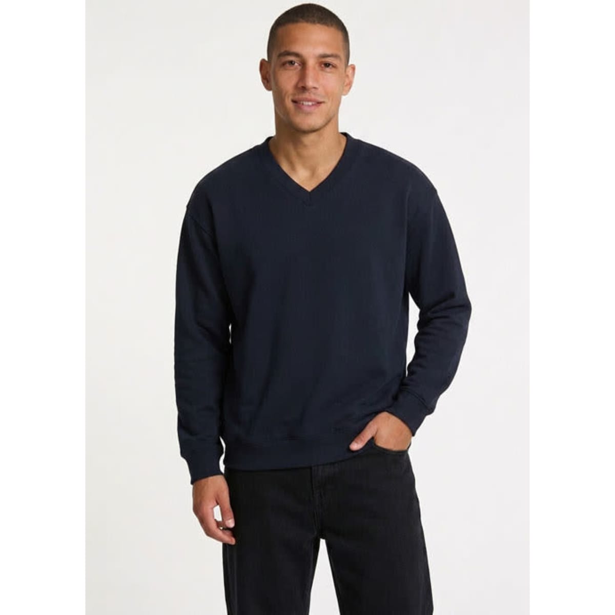 A black unisex V-neck fleece jumper with a relaxed fit and long sleeves, featuring a brand label.