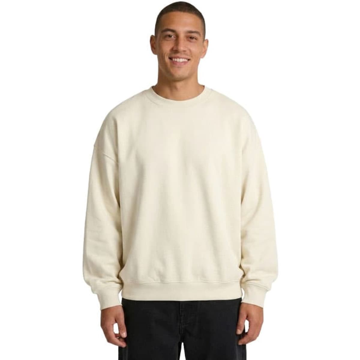 A beige oversize crew neck fleece jumper featuring dropped shoulders and a relaxed fit. It includes a logo on the label.