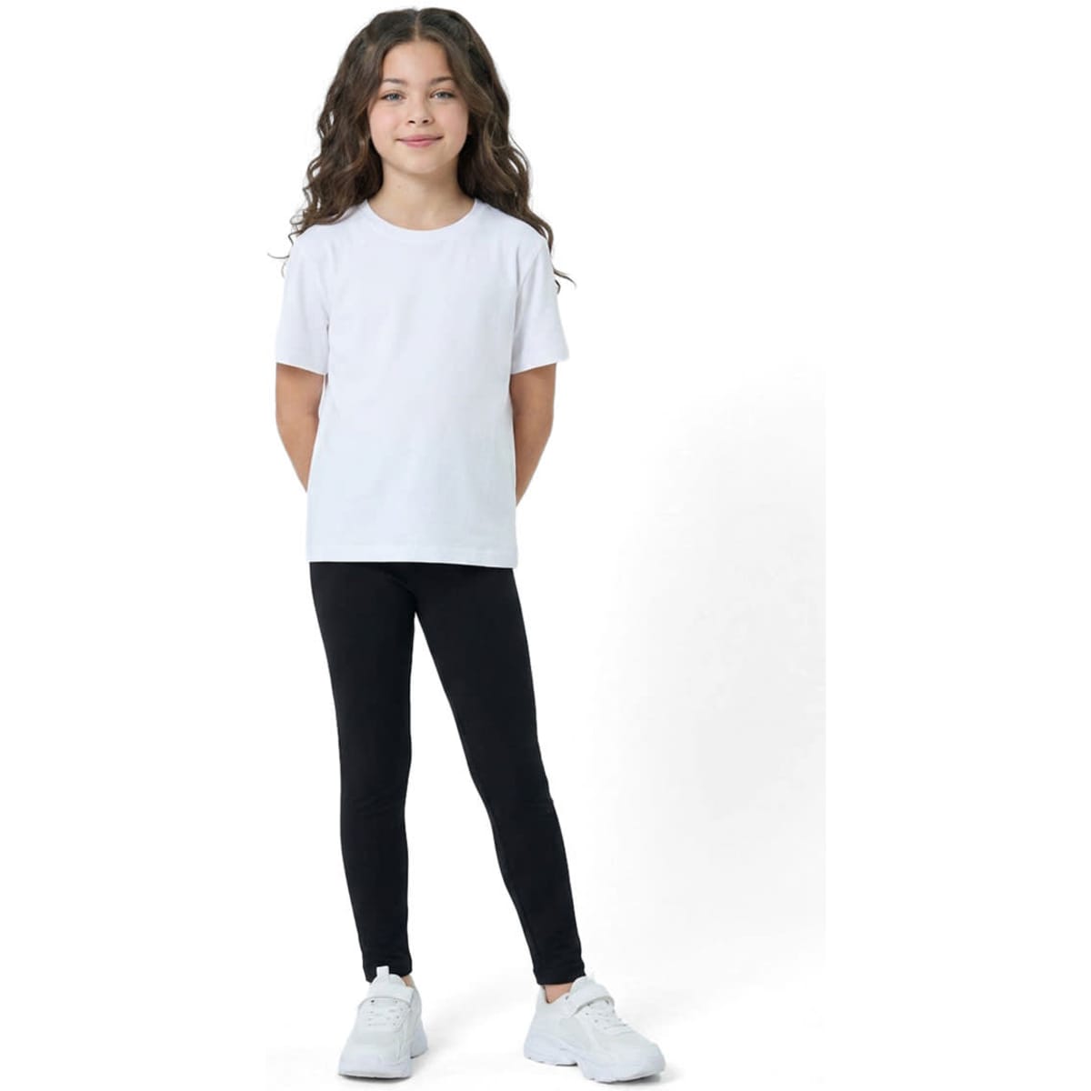 Kids' black leggings paired with a white t-shirt, featuring a logo on the shirt, worn by a girl with curly hair.