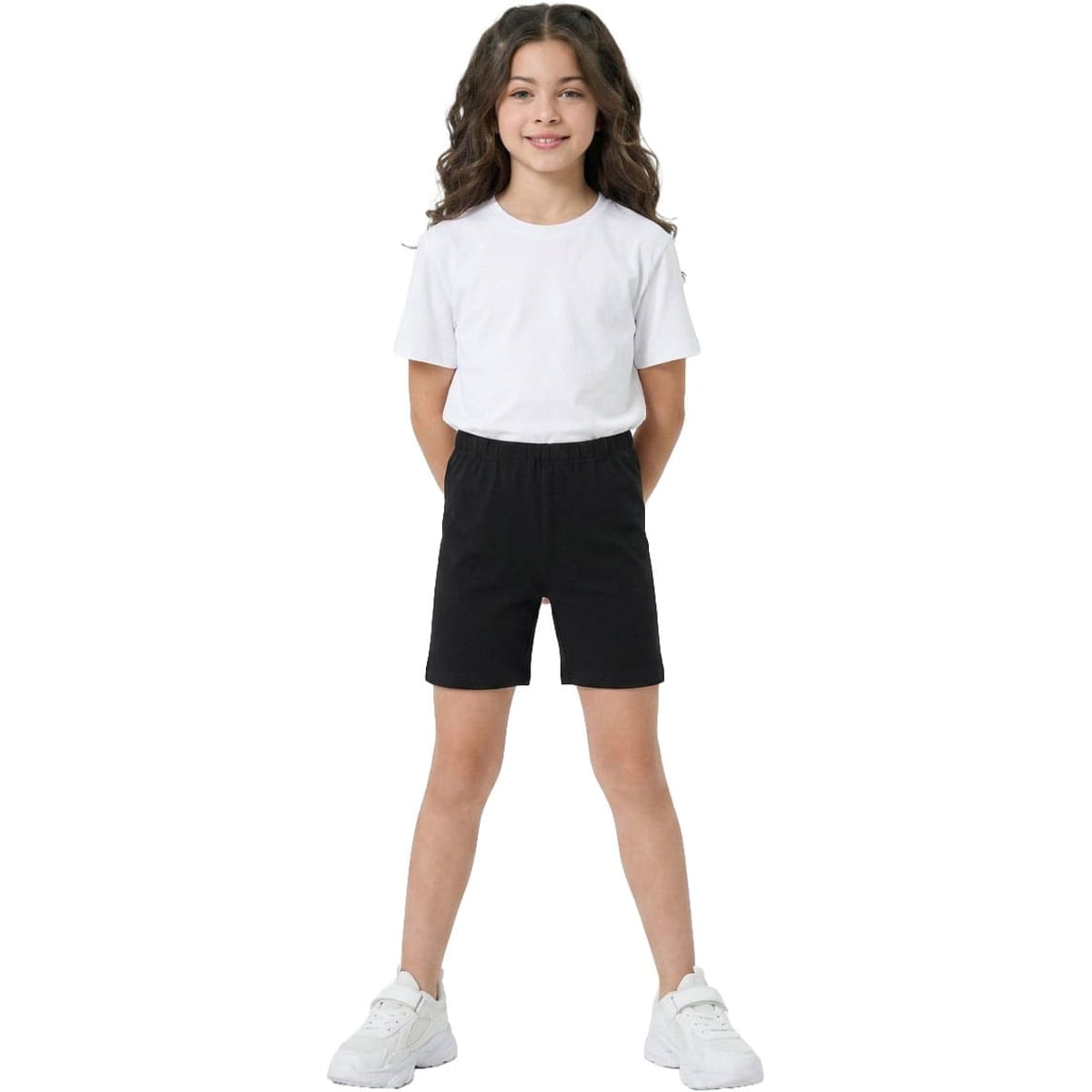 Black cotton spandex shorts for girls, featuring an elastic waistband and paired with a white t-shirt.