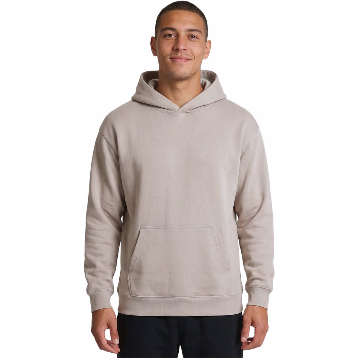 A light beige men's hoodie featuring a kangaroo pocket and a hood. The model is smiling and wearing the hoodie.