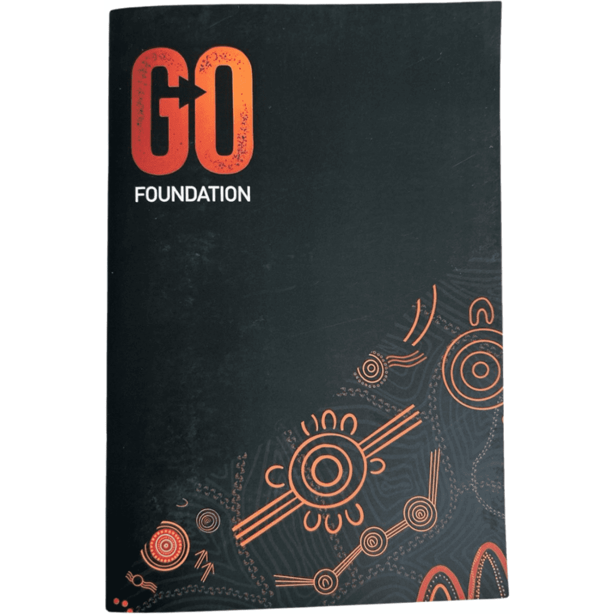 A black A5 saddle stitch soft cover notebook with orange and red designs and a logo on the front.