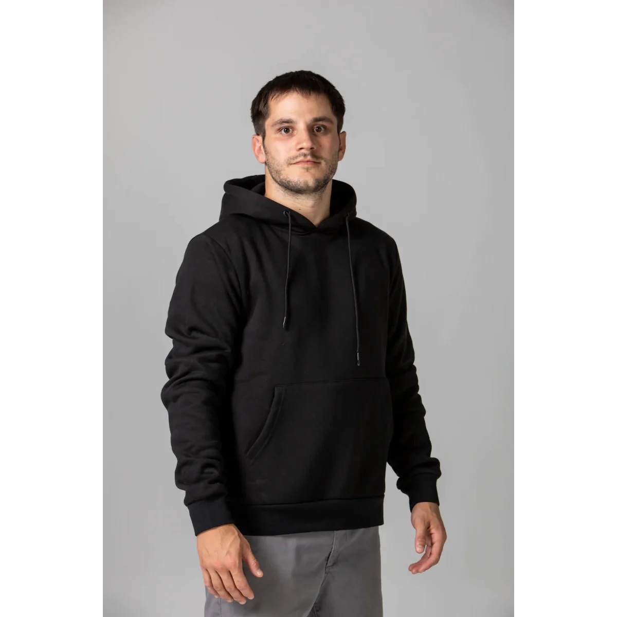 A black hoodie with a front pocket and drawstrings, featuring a logo on the right side.