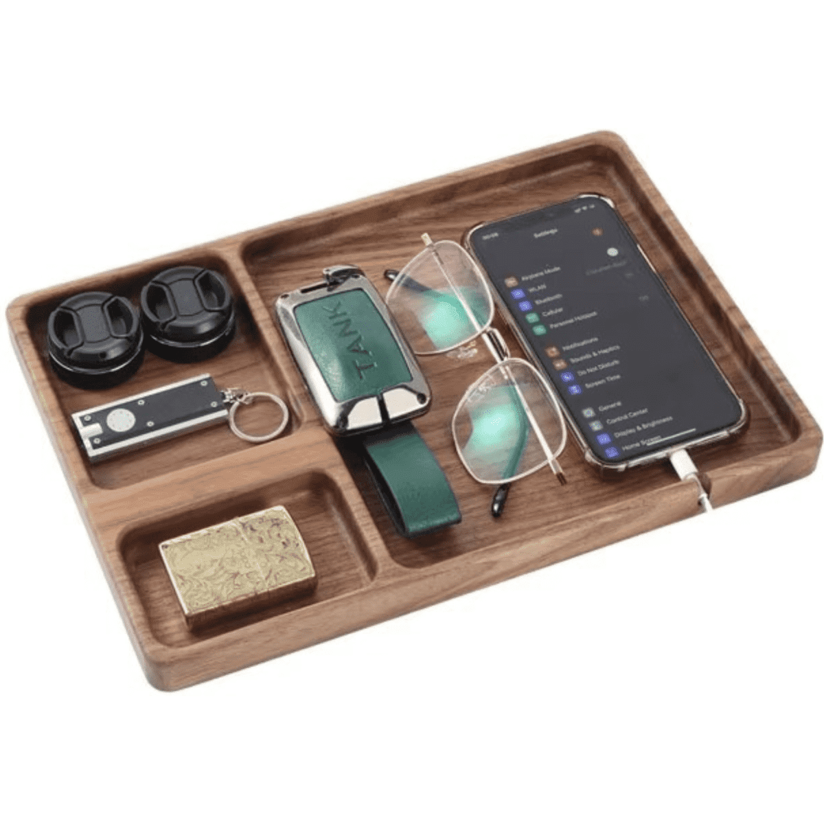 A wooden caddy with a phone, glasses, wireless earbuds, a USB drive, and a small block, featuring a sleek design.