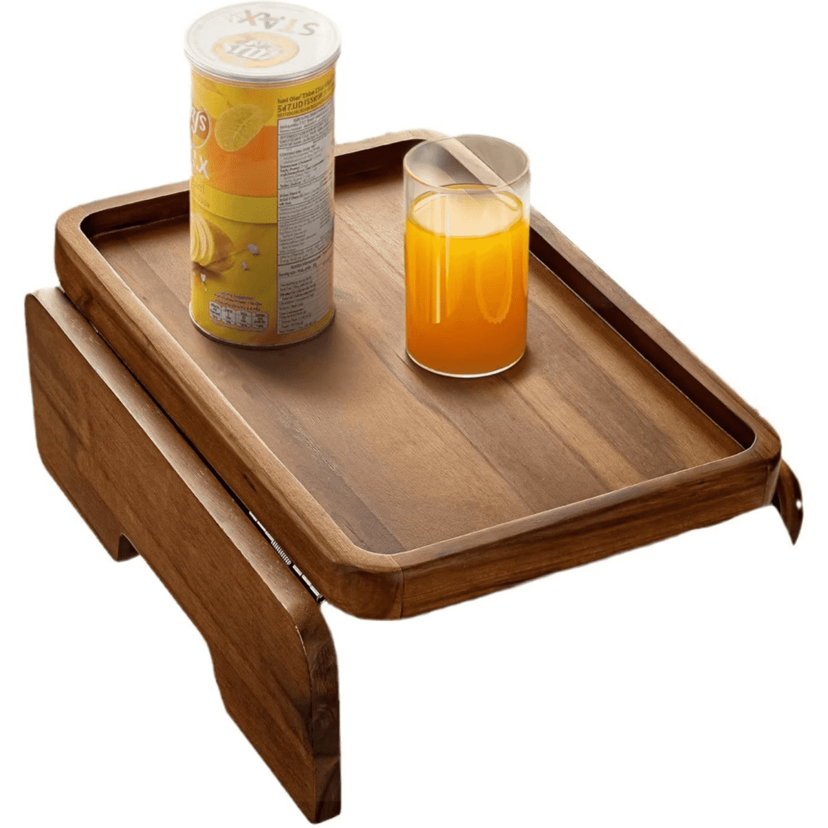 A wooden lounge caddy with an orange drink in a glass and a can of soda on the tray.