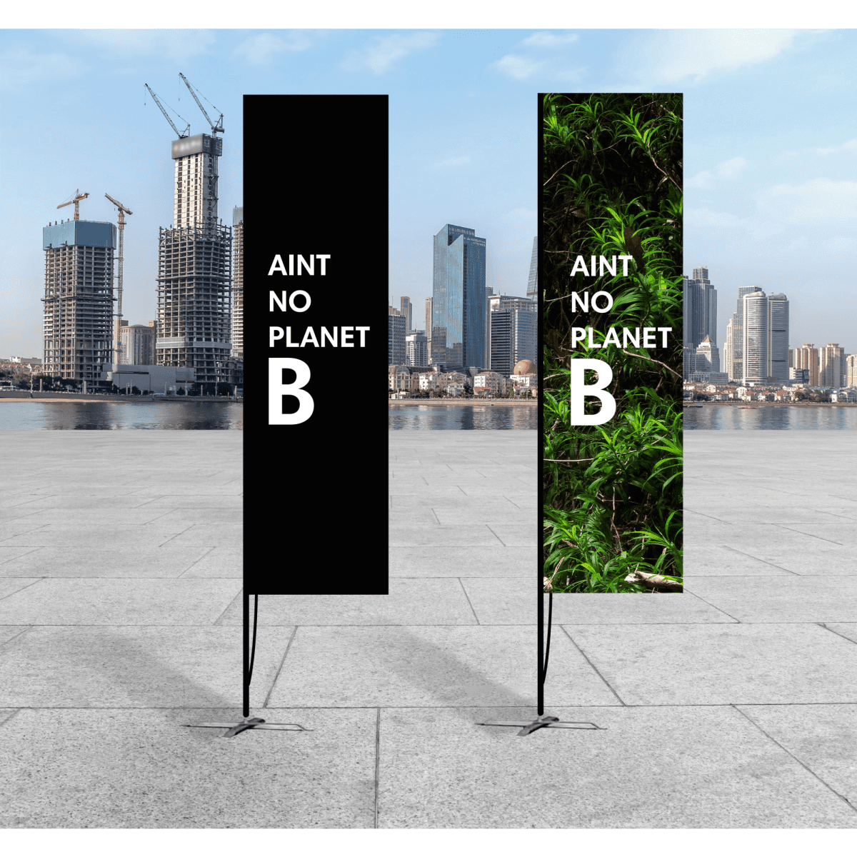 Two tall banners: one black and one featuring greenery, set against a city skyline in an outdoor space. Both have a logo.