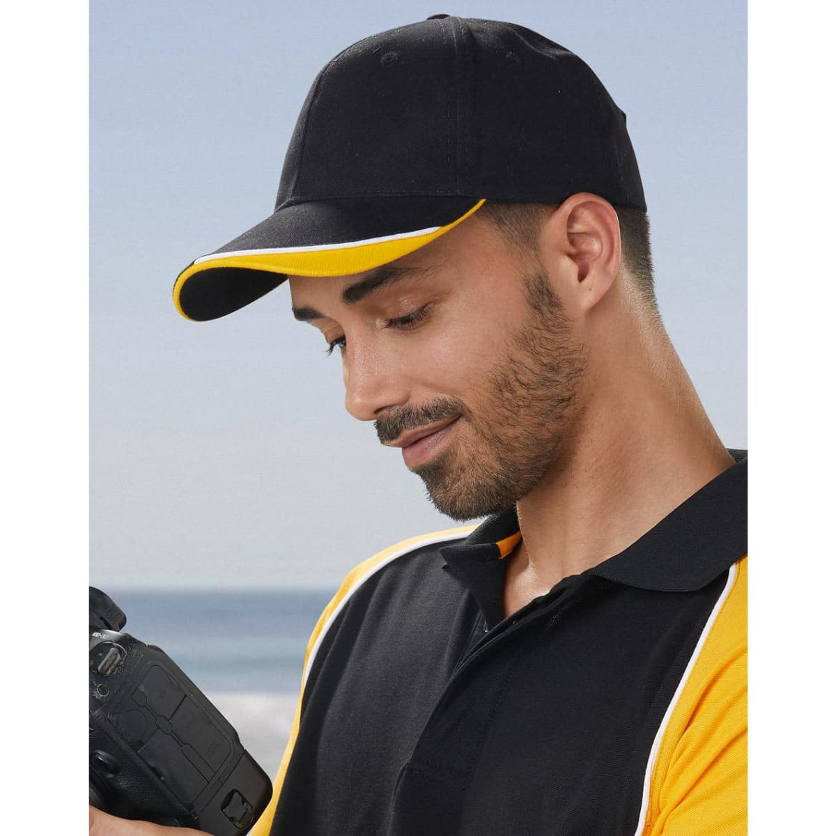 A red cap with a peak and contrasting black and white accents, featuring a logo.