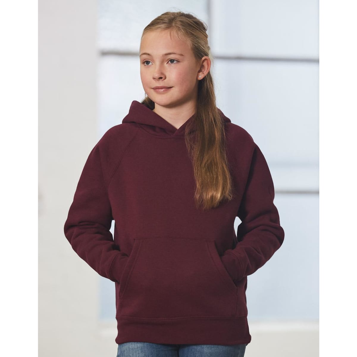 A maroon kids' fleece hoodie with a front pocket and a hood, worn by a girl with long hair.