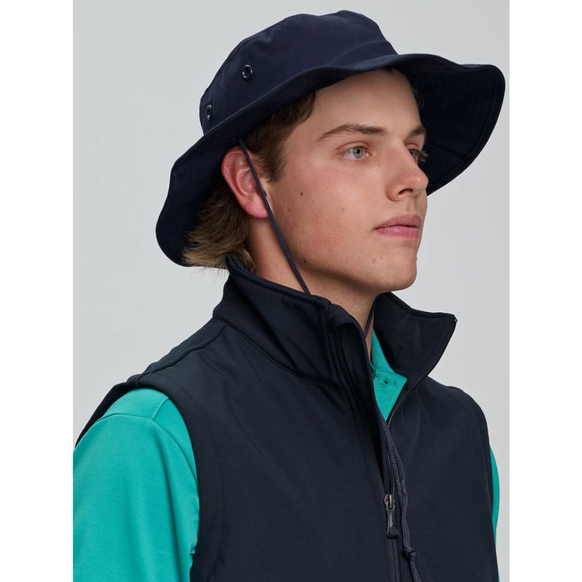 A blue surf hat with a wide brim and a clip-on chin strap, featuring a logo on the side.