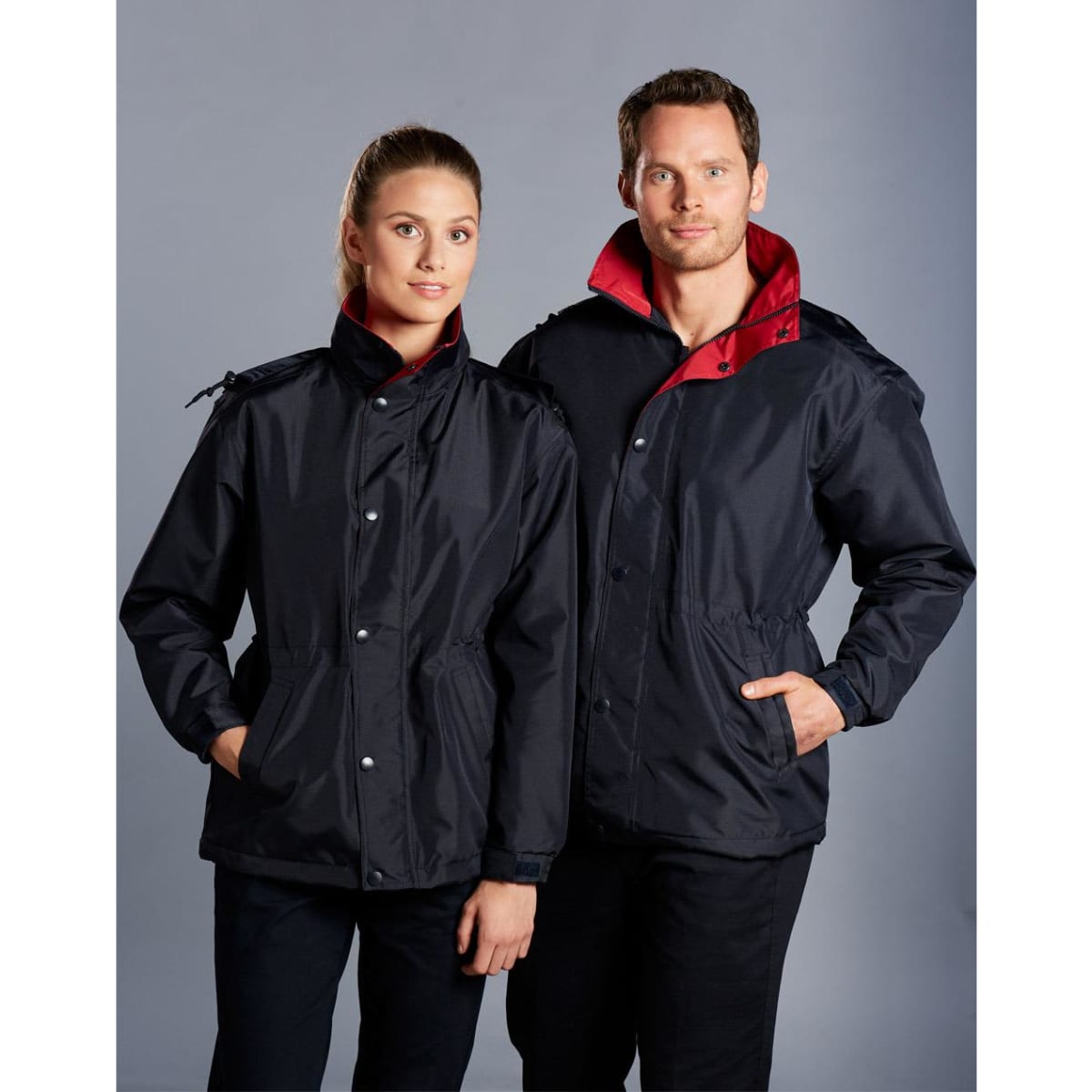 A black varsity jacket with a red collar, displayed on two models, featuring a logo on the chest.
