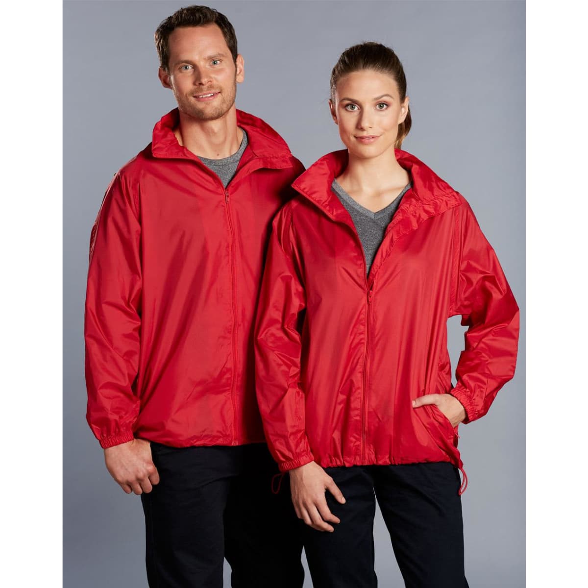 A red outdoor activity spray jacket featuring a zip-up front and adjustable cuffs, displayed on male and female models.