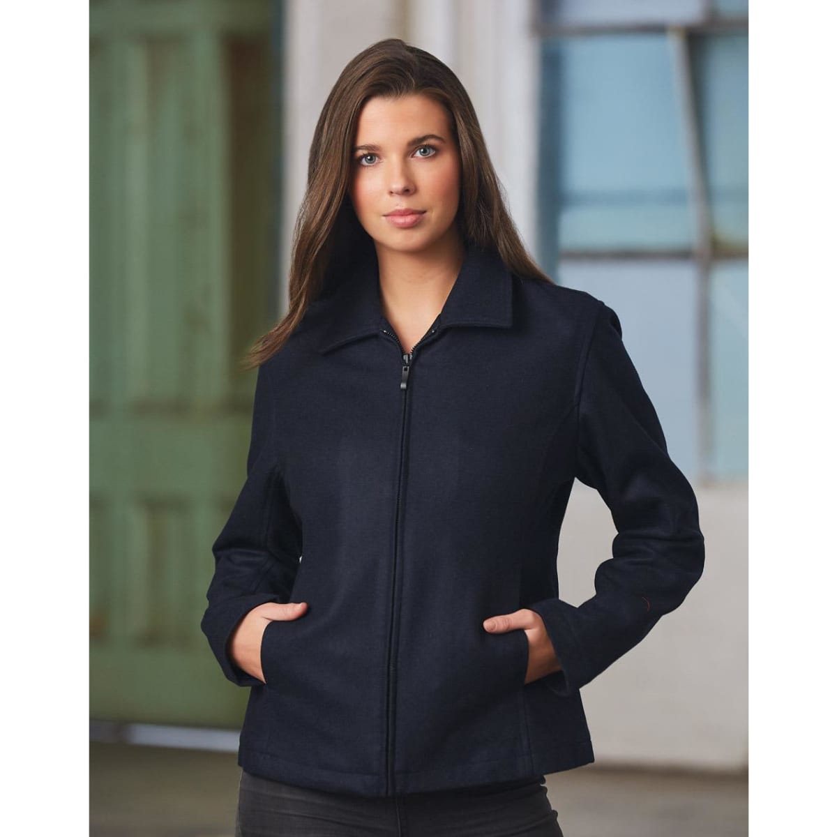 A wool blend corporate jacket in navy, featuring a zip front and side pockets, worn by a model. The jacket has a logo.