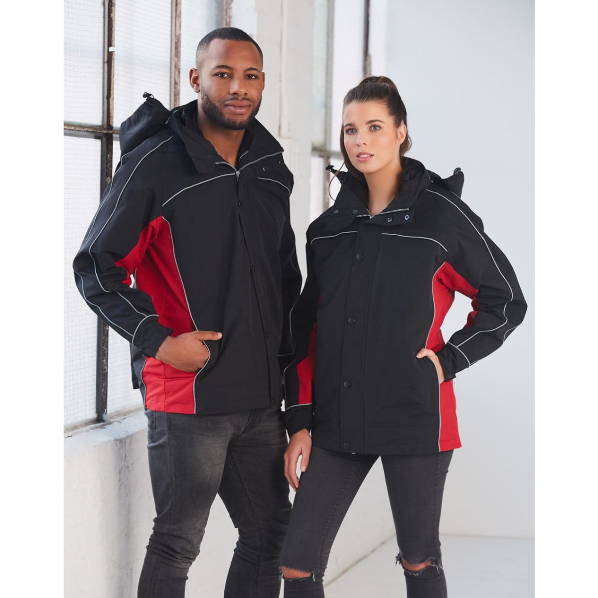 A black and red 3-in-1 jacket with a hood, worn by two models, featuring a branded logo.