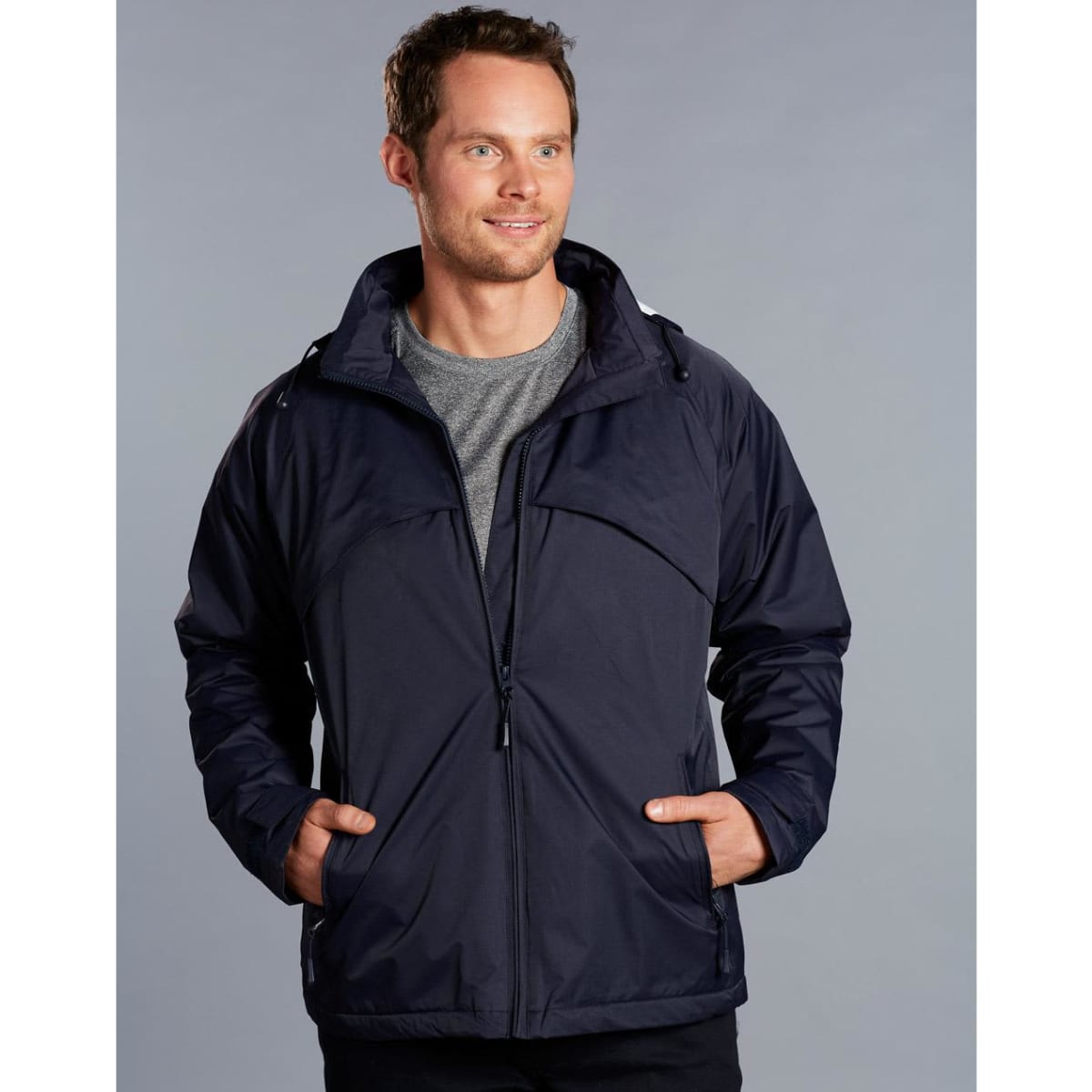 A men's navy chalet jacket with a zip front, featuring a hood and two side pockets, worn by a model.