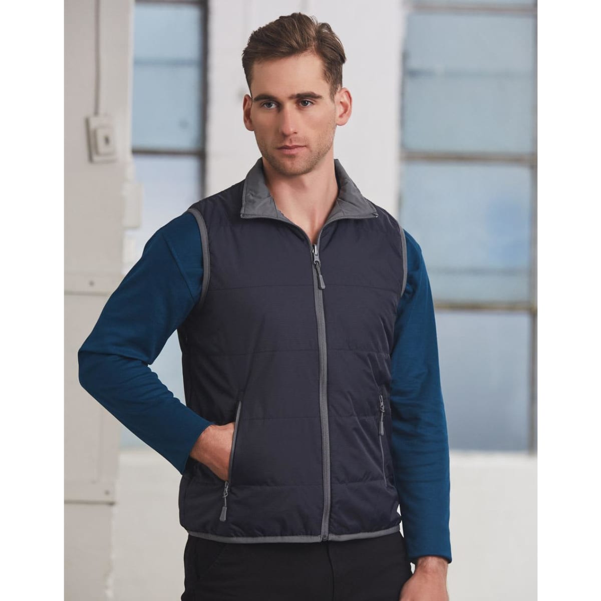 A navy blue men's vest with grey accents, featuring a zip front and pockets.