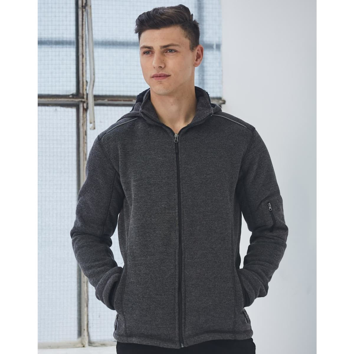 Men's heather bonded fleece jacket in dark grey, featuring a zip front and hood, with a logo on the sleeve.
