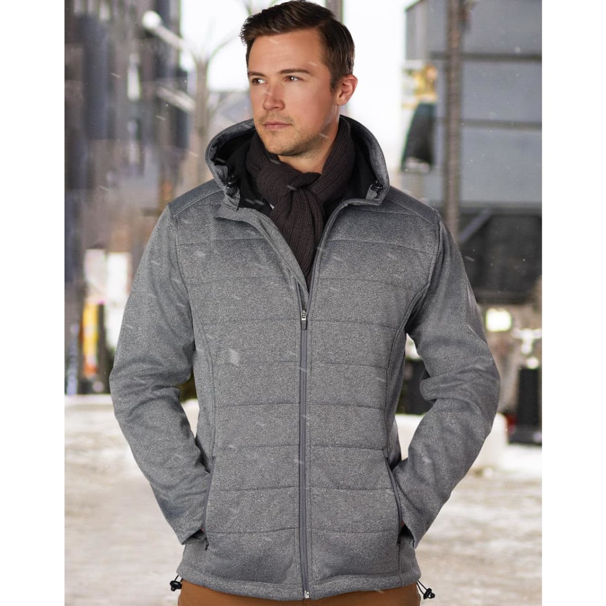 A men's cationic quilted jacket in shades of grey, featuring a zip front and a hood. The model wears a scarf.