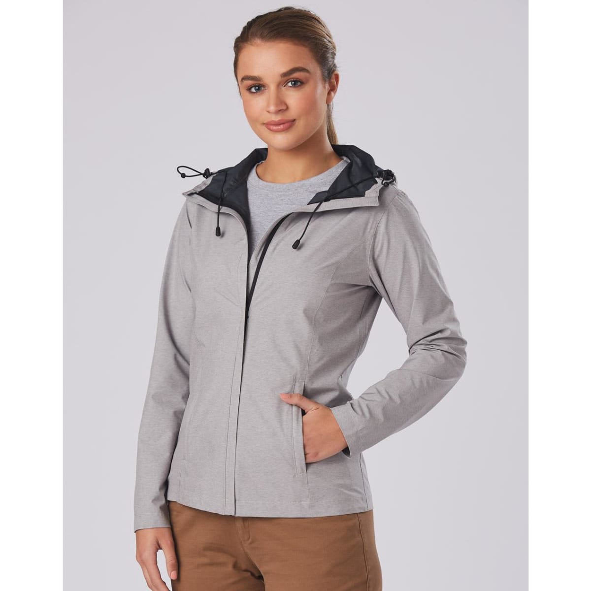 A waterproof performance jacket in light grey with a black hood and adjustable features. It has a subtle logo.