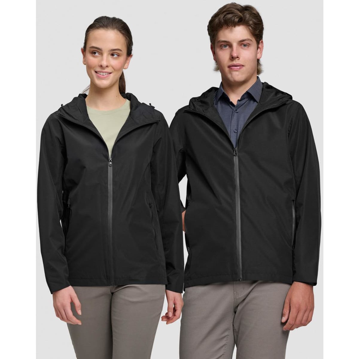 A unisex black waterproof jacket, featuring a zip-up front and a hood, displayed on male and female models.