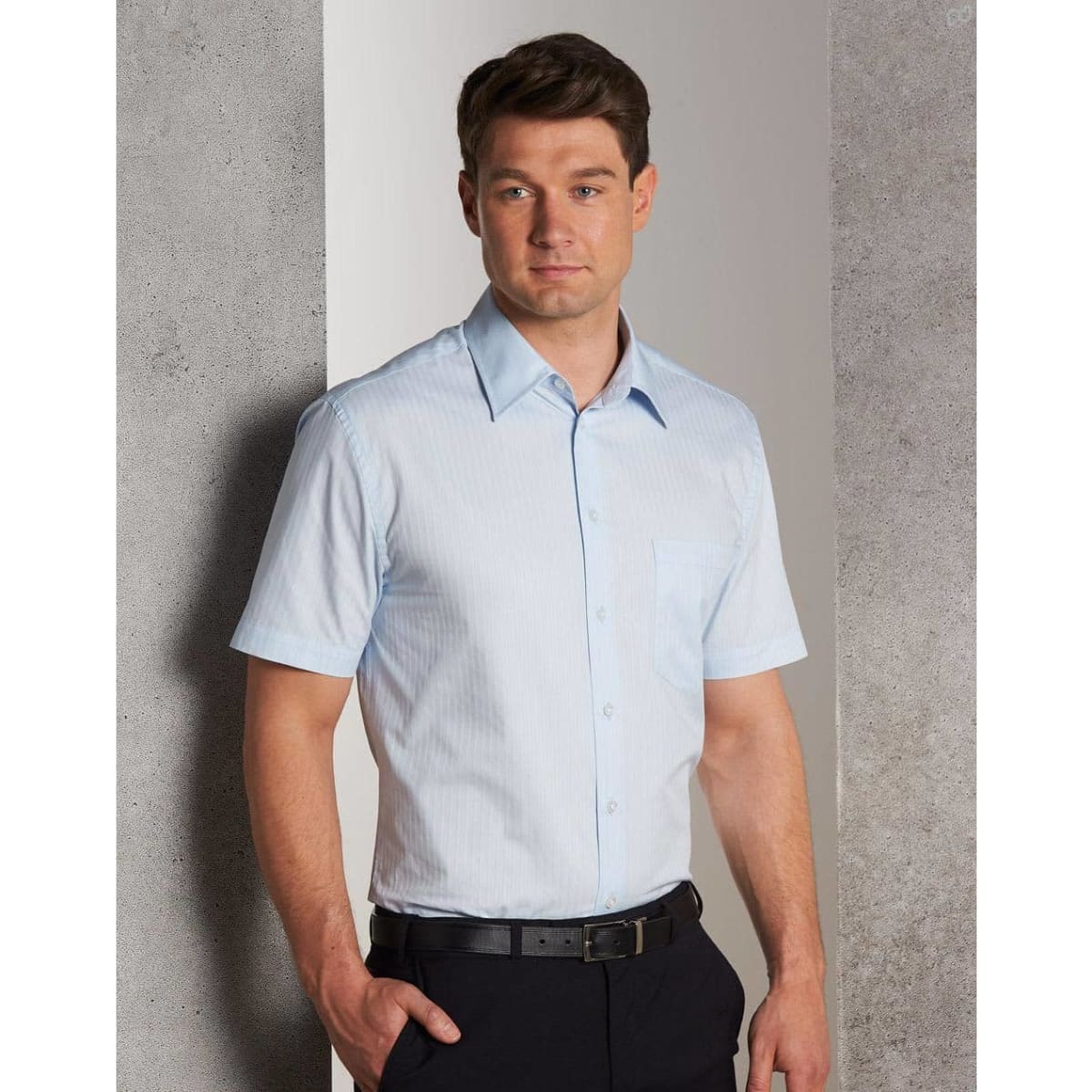 A short-sleeved, self-striped button-up shirt in light blue with a chest pocket, paired with dark trousers.