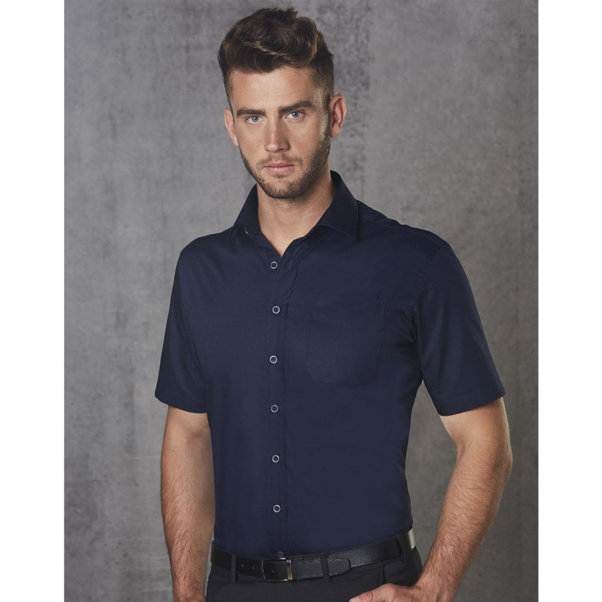 A short-sleeved navy blue button-up shirt with a pocket and a logo on the chest.