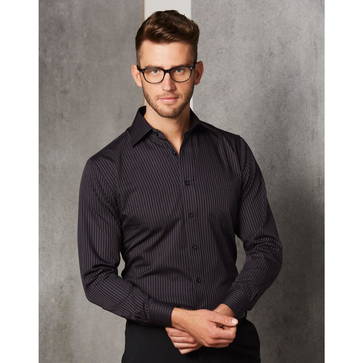 A men's long sleeve button-up shirt with a black and dark striped pattern. It features a collar and a logo.