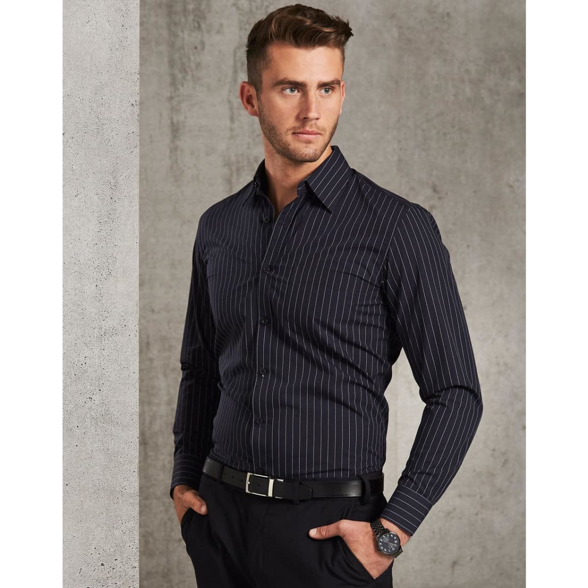 A men's long sleeve button-up shirt in navy with white pin stripes, featuring a logo on the chest.