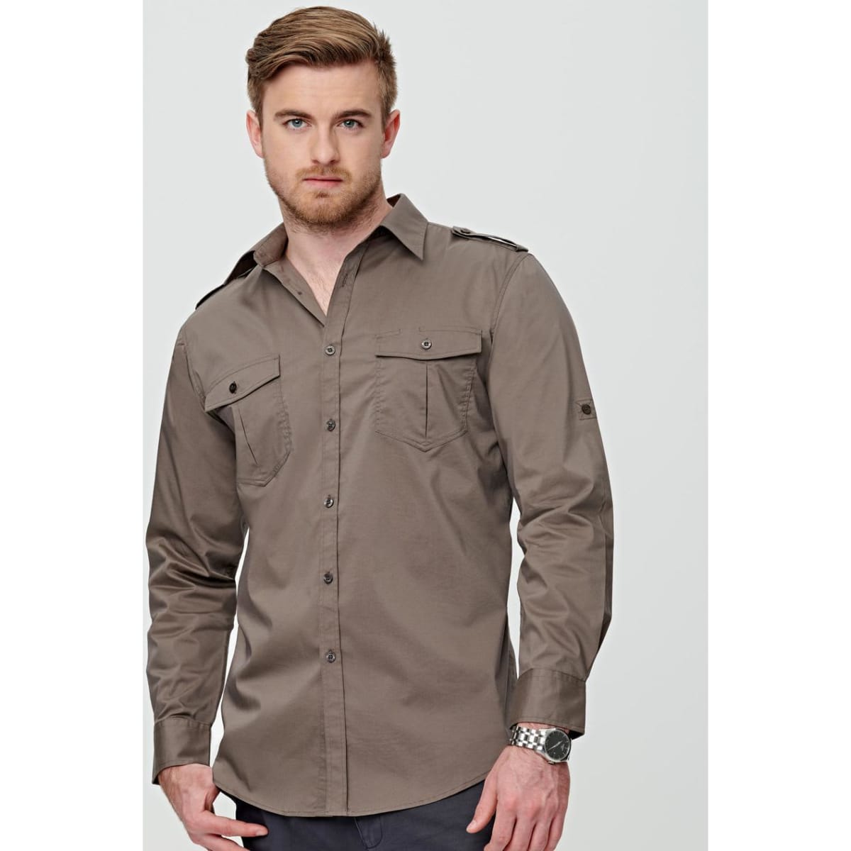 A khaki long sleeve military shirt with a button-up front, featuring shoulder epaulettes and chest pockets.