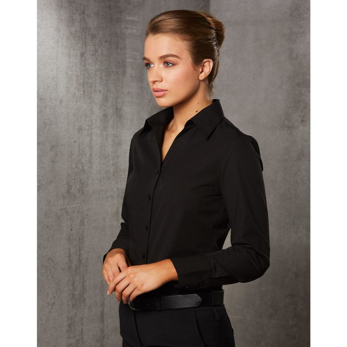 A black long sleeve button-up shirt for women, featuring a fitted design and a collar.