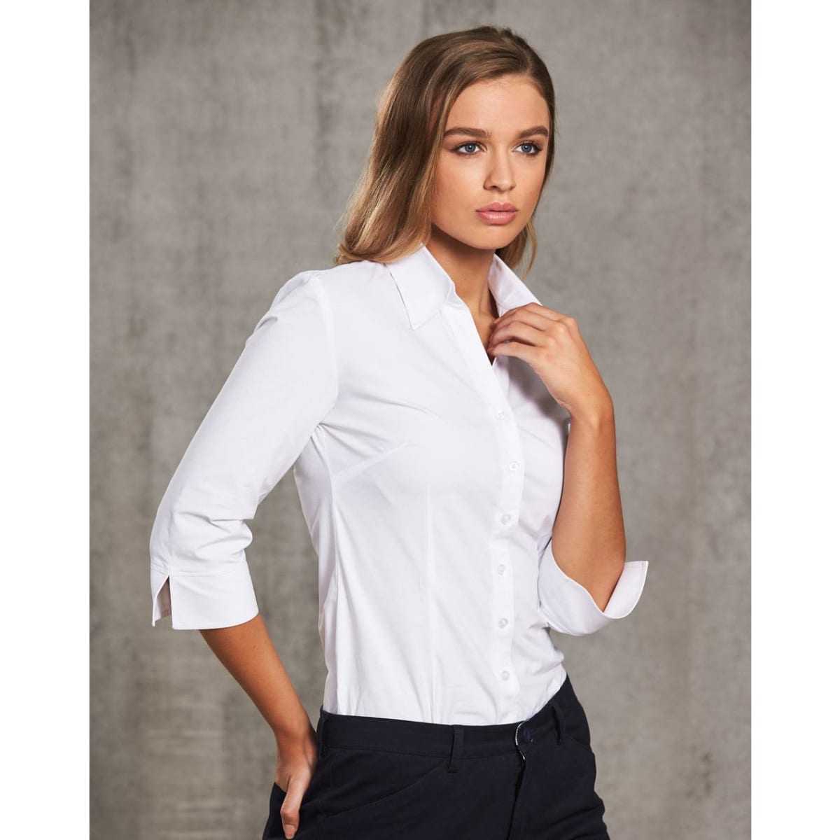 A women's white cotton/poly stretch 3/4 sleeve button-up shirt showcased on a model.