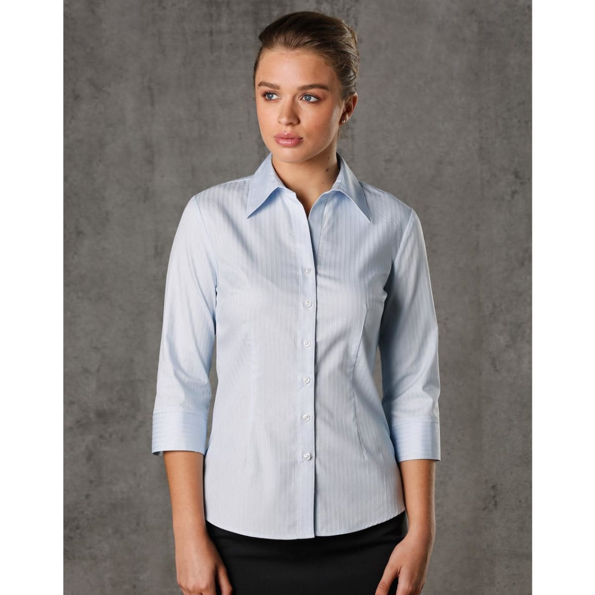 A light blue women's 3/4 sleeve button-up shirt with a self-stripe pattern and a logo.