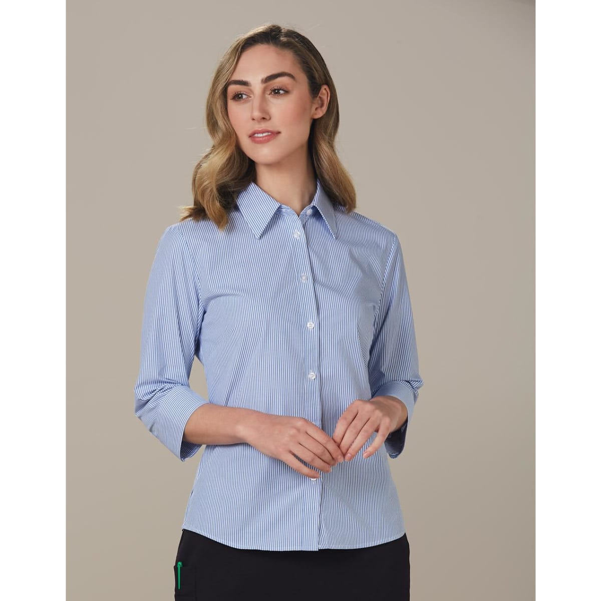 A women's button-up shirt featuring blue and white stripes and 3/4 sleeves, with a collar and a logo.