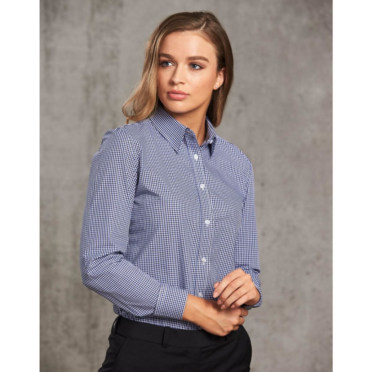 A ladies' long-sleeve button-up shirt in navy and white check pattern, featuring a collar and logo branding.