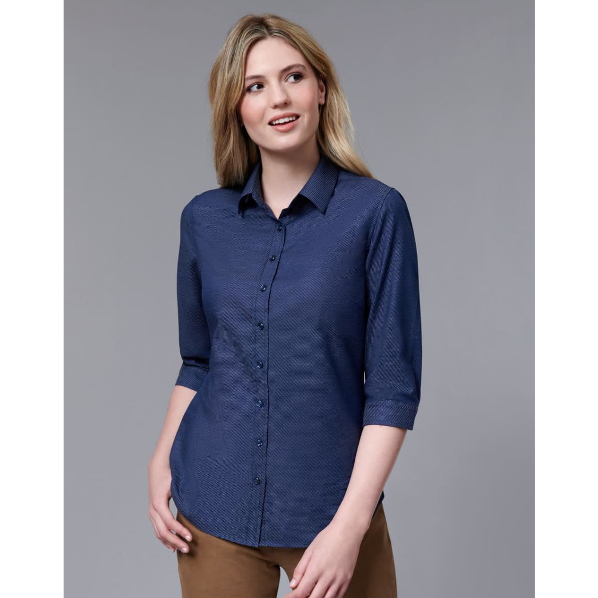 A navy button-up shirt with a pin dot pattern and 3/4 sleeves, featuring a collar and branded logo.