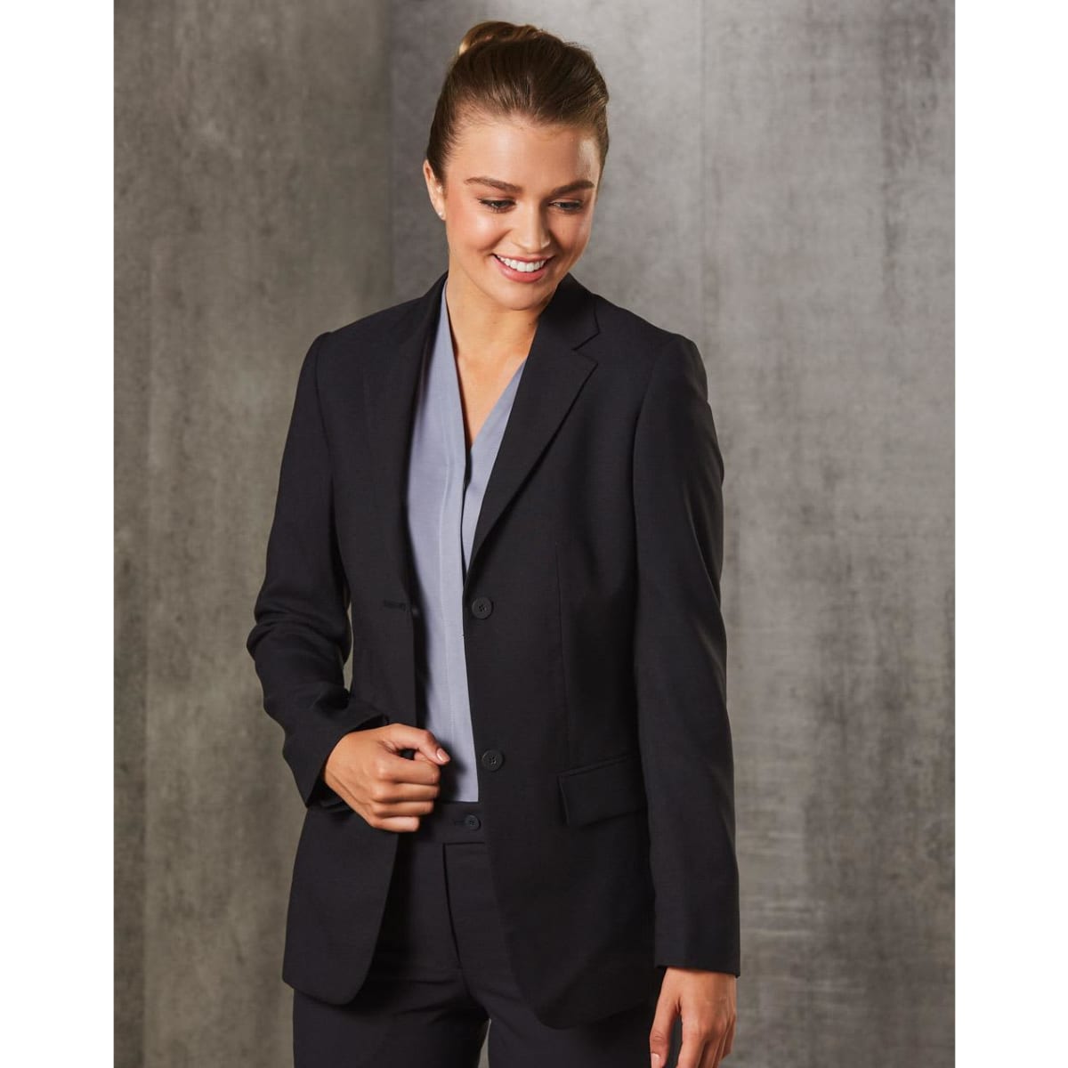 A women's mid-length jacket in black poly/viscose stretch with two buttons, featuring a tailored fit and a logo.