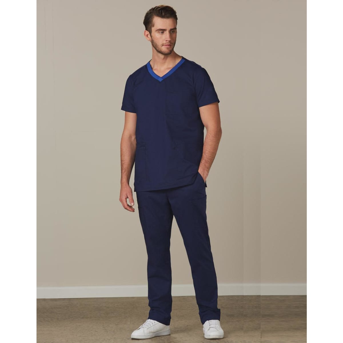 Men's solid navy scrub pants paired with a matching navy scrub top, featuring a logo on the garment.