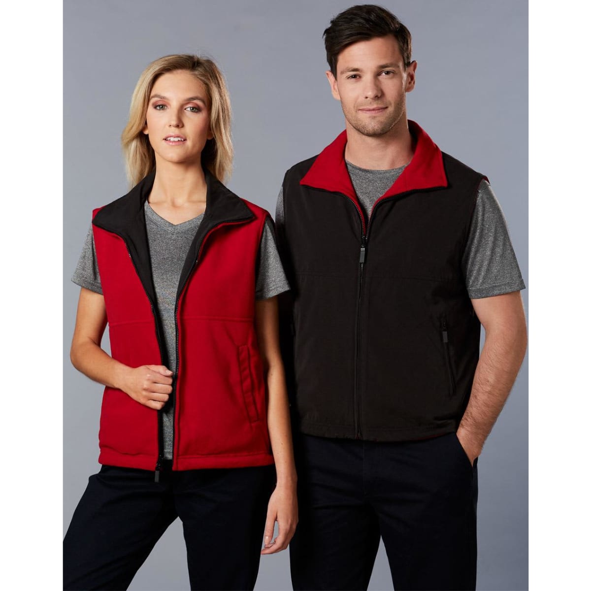 A unisex reversible vest featuring red and black colours, displayed on a male and female model. It includes a logo.