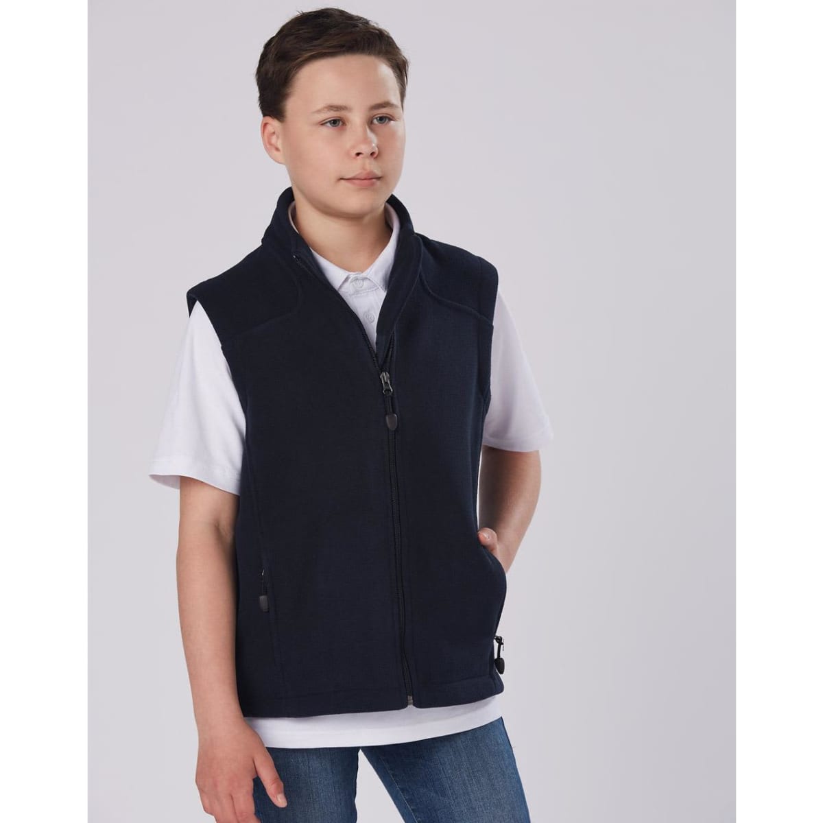 A diamond fleece vest in navy worn by a child, featuring a zip fastening and side pockets.