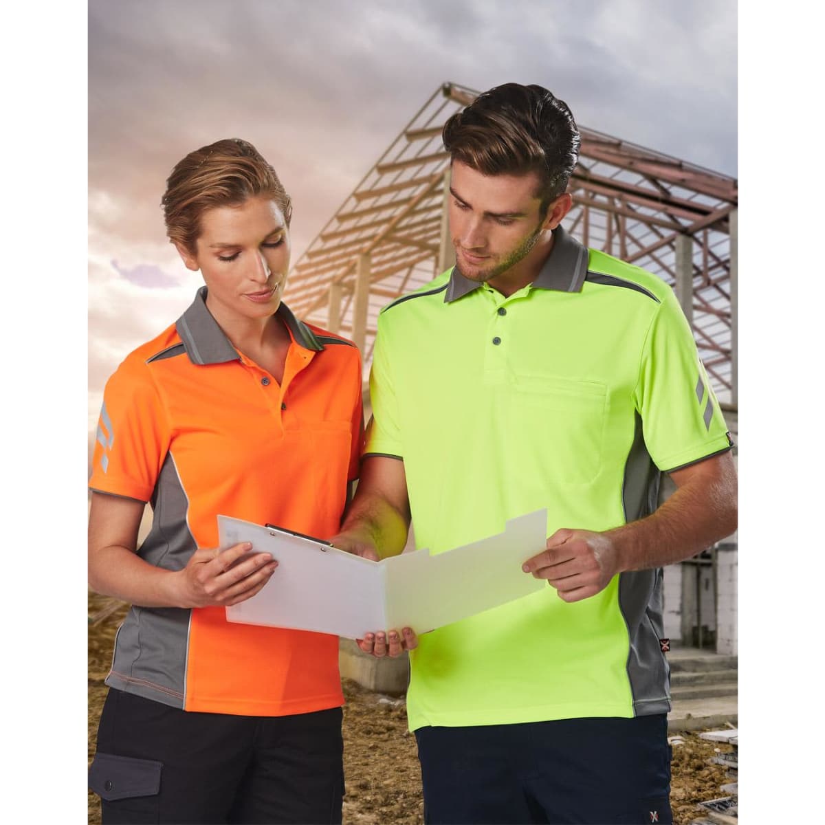 Two individuals wear the AIWX Vented Cooldry Polo shirts in bright orange and high-visibility yellow, with grey accents.
