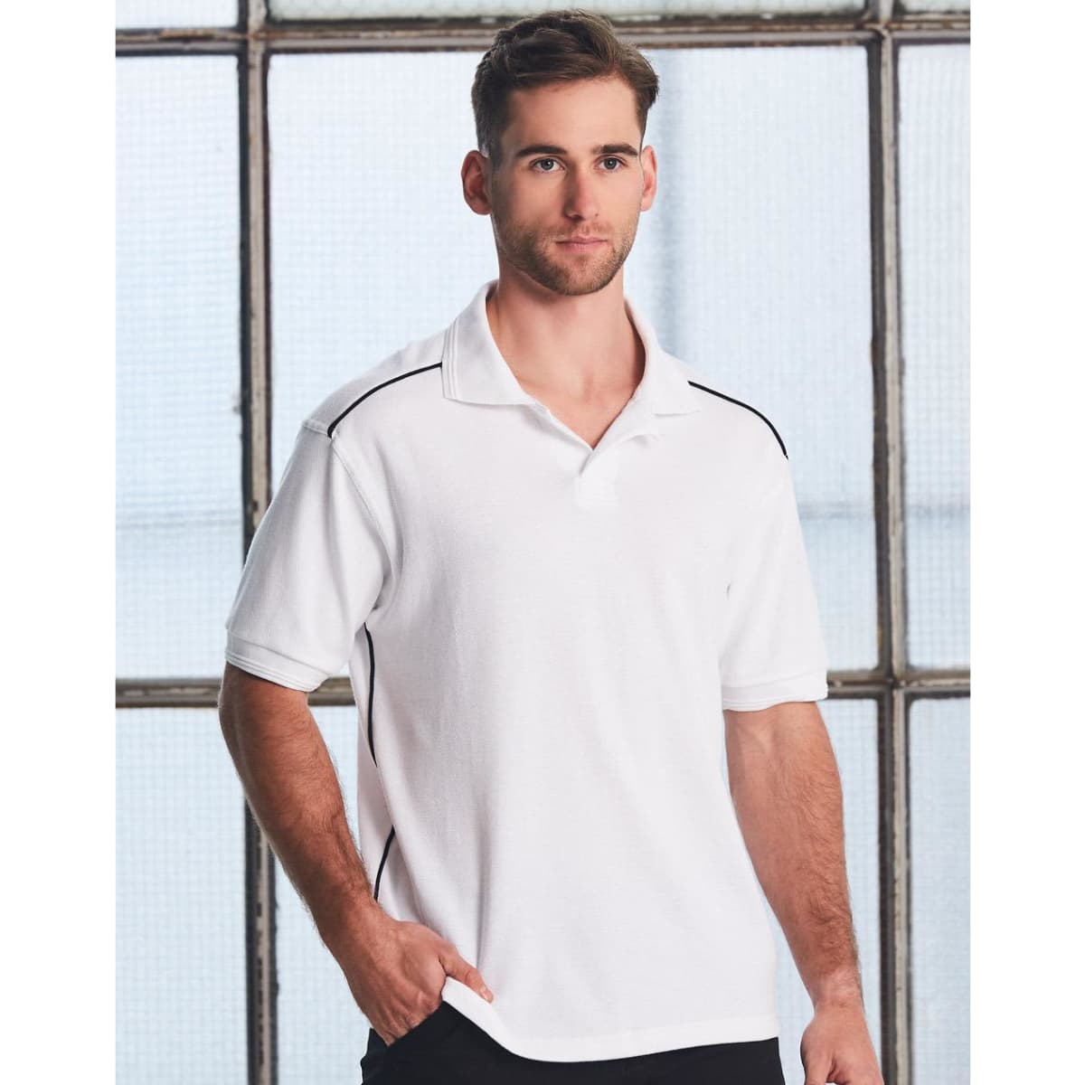 A white polo shirt featuring black accents, designed for men, with a logo on the chest.