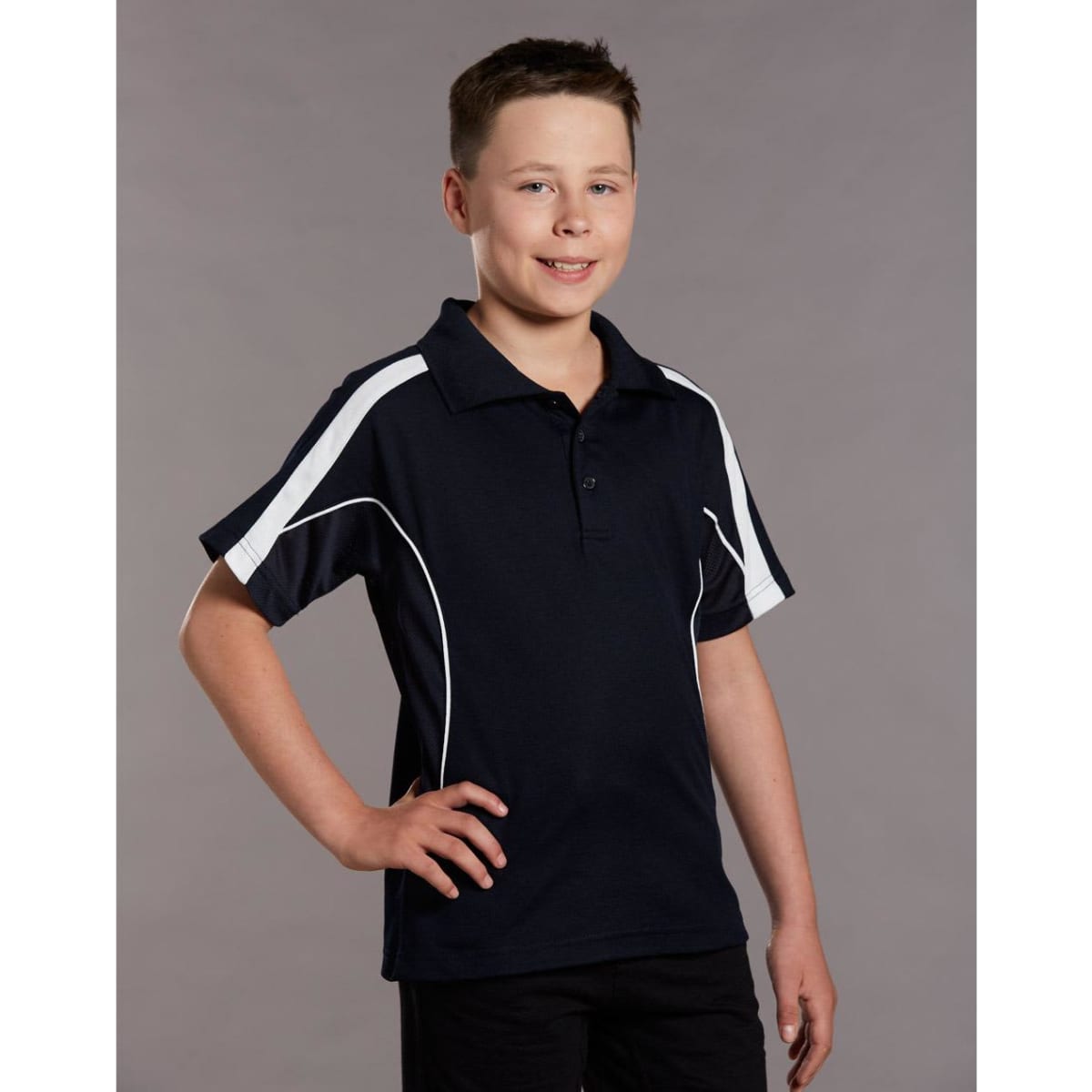 A young boy wearing a navy blue polo shirt with white accents and a logo. The shirt has a classic collar and short sleeves.