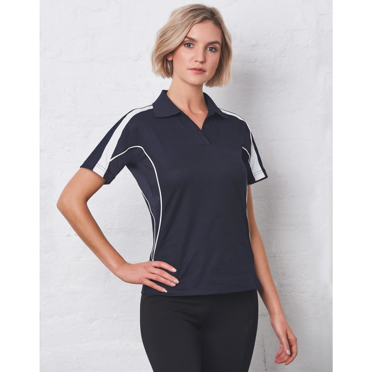 A navy polo shirt featuring white side panels and a subtle branding logo. Ideal for casual or sporty settings.