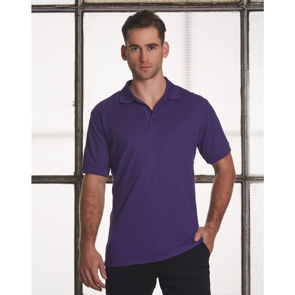 A purple men's polo shirt featuring short sleeves and a collar. The shirt has a logo on it.
