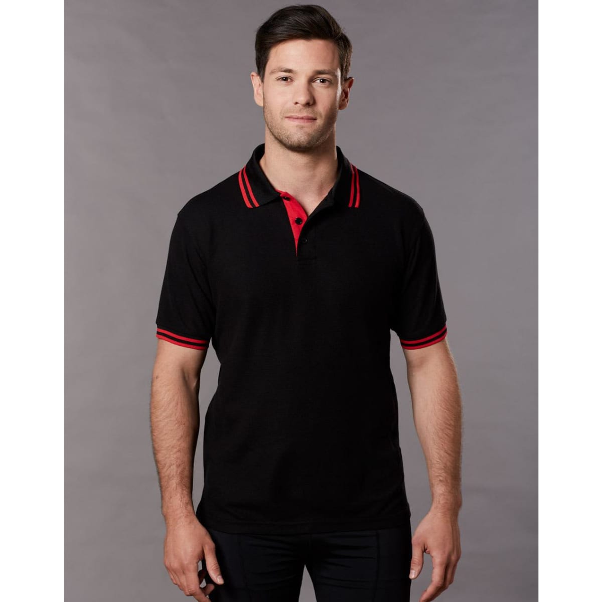 A black polo shirt with red collar and sleeve stripes, featuring a logo on the chest.