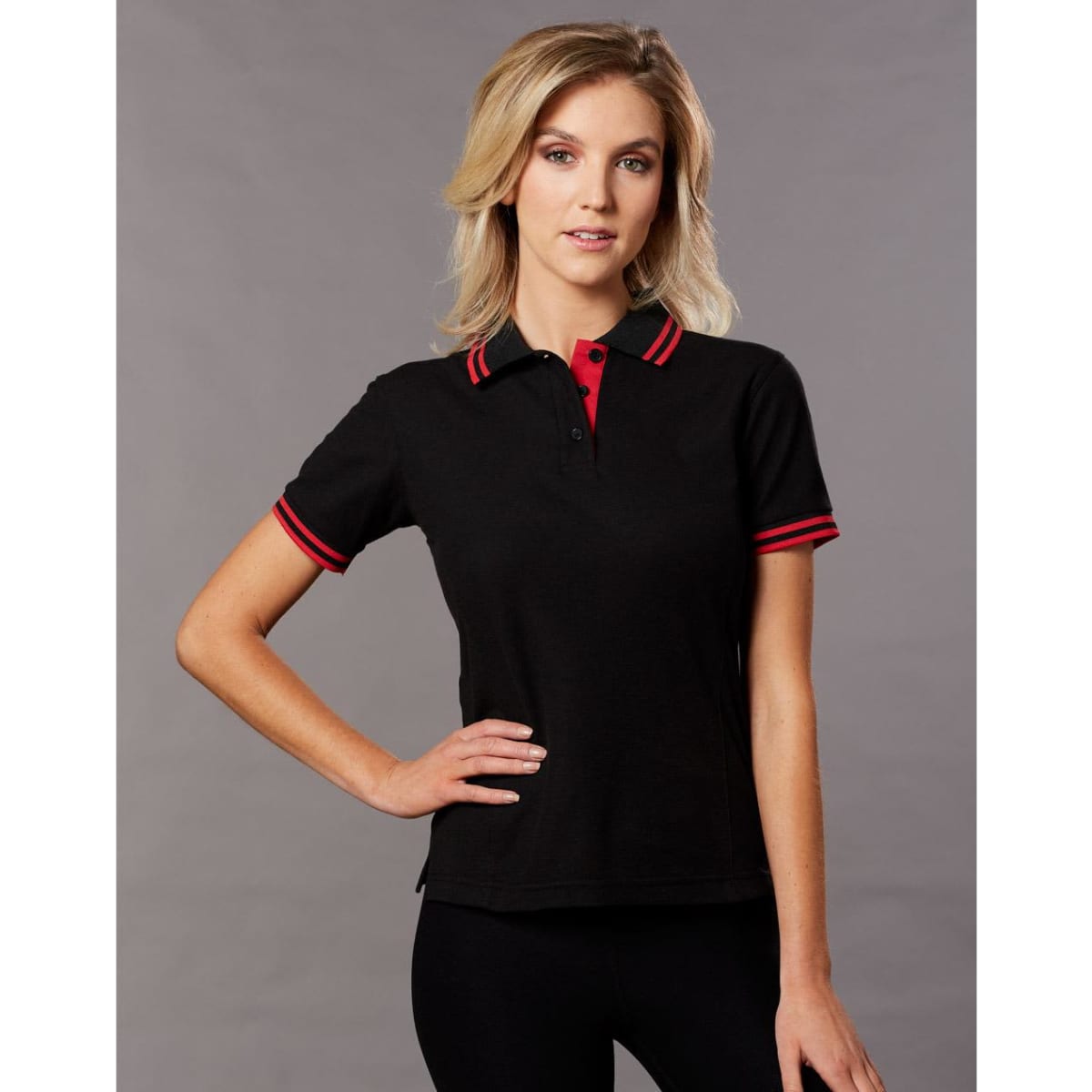 A black polo shirt with red collar and sleeve stripes, featuring a logo on the chest.