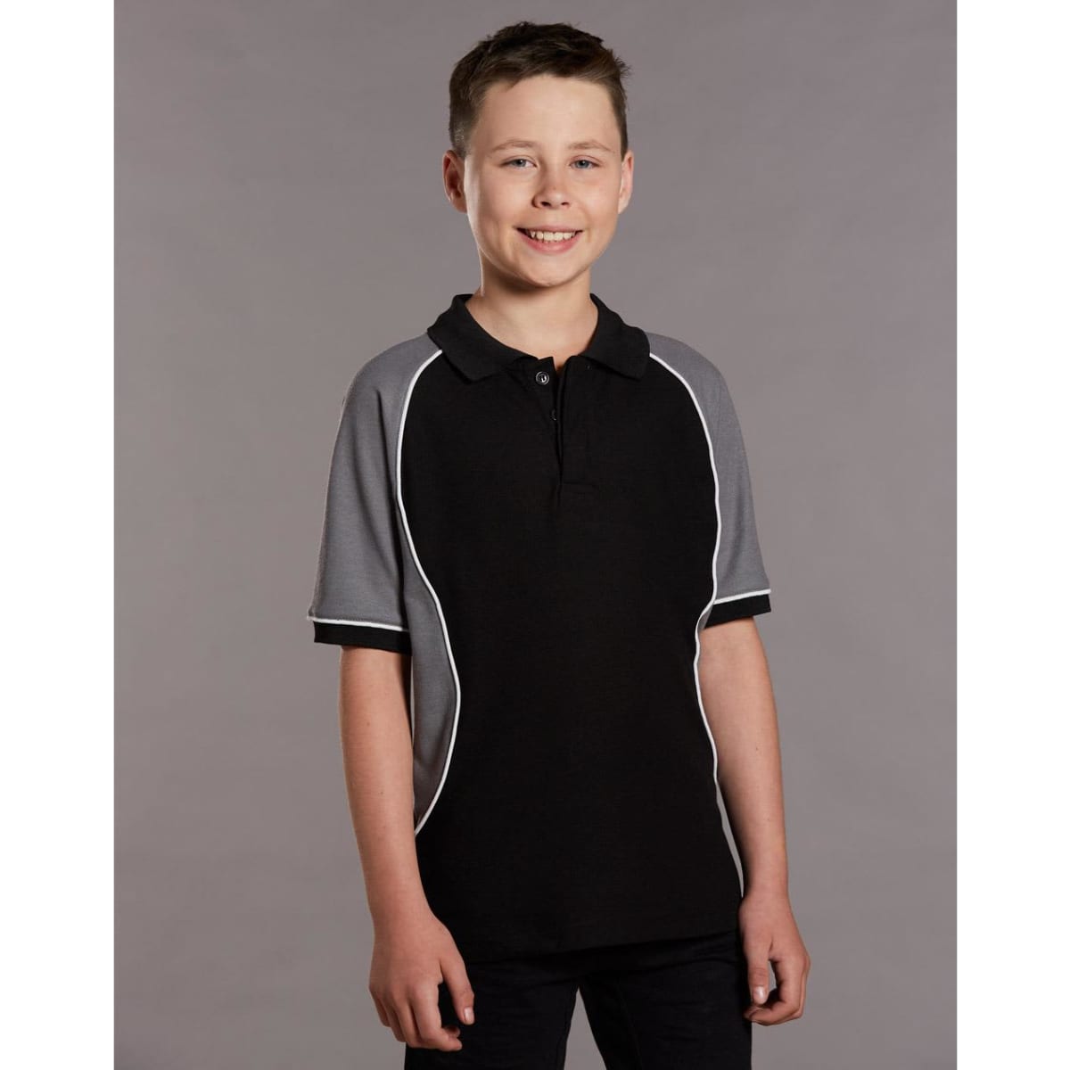 A black and grey kids' polo shirt with short sleeves and a collar, featuring a logo.
