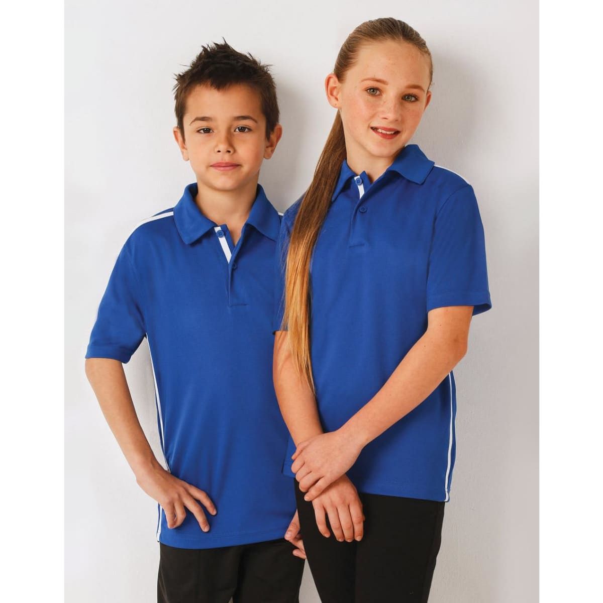 A blue kids' polo shirt featuring white contrast stripes, with a logo on the front. Two children model the shirt.