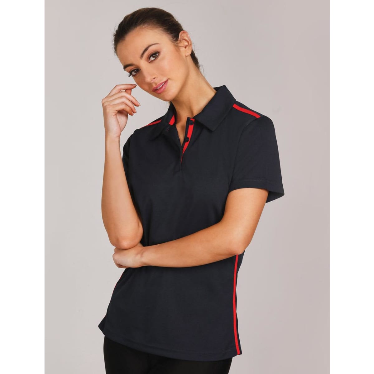 A navy blue polo shirt with short sleeves features red contrast stripes and a logo on the chest.