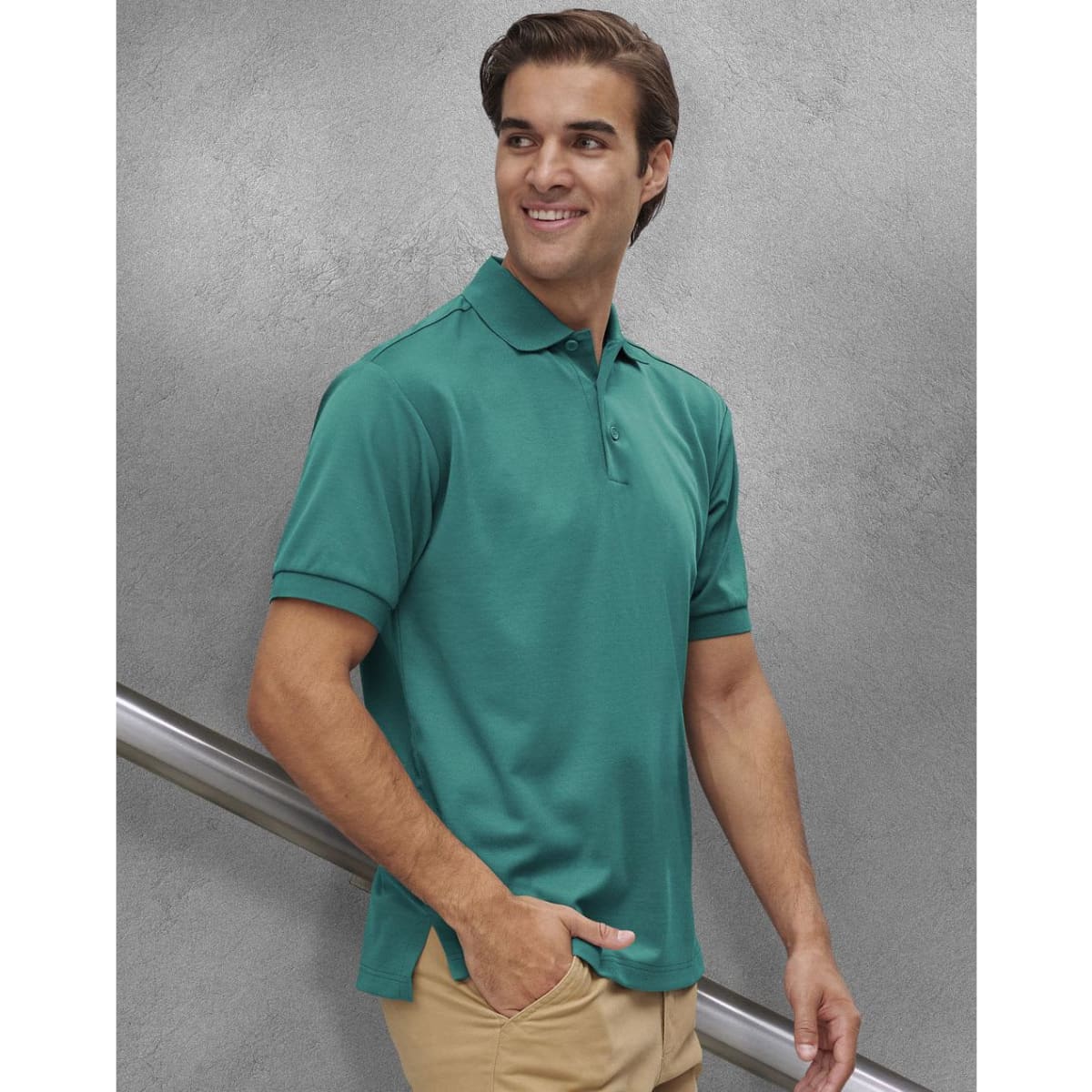 A men's sustainable poly/cotton polo shirt in green, featuring a collar and short sleeves, displayed on a model.